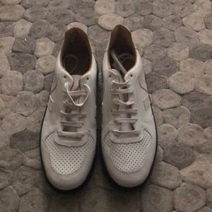 Veja white top low sneakers with black sole.